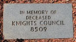 A plaque in the ground that reads " in memory of deceased knights council 8 5 0 9 ".