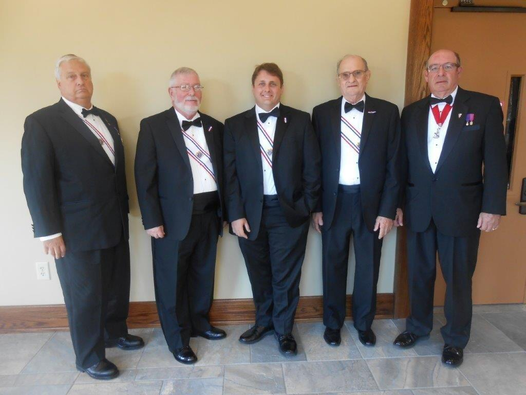 A group of men in suits and ties standing next to each other.